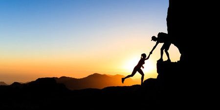 teamwork-couple-helping-climb-mountains